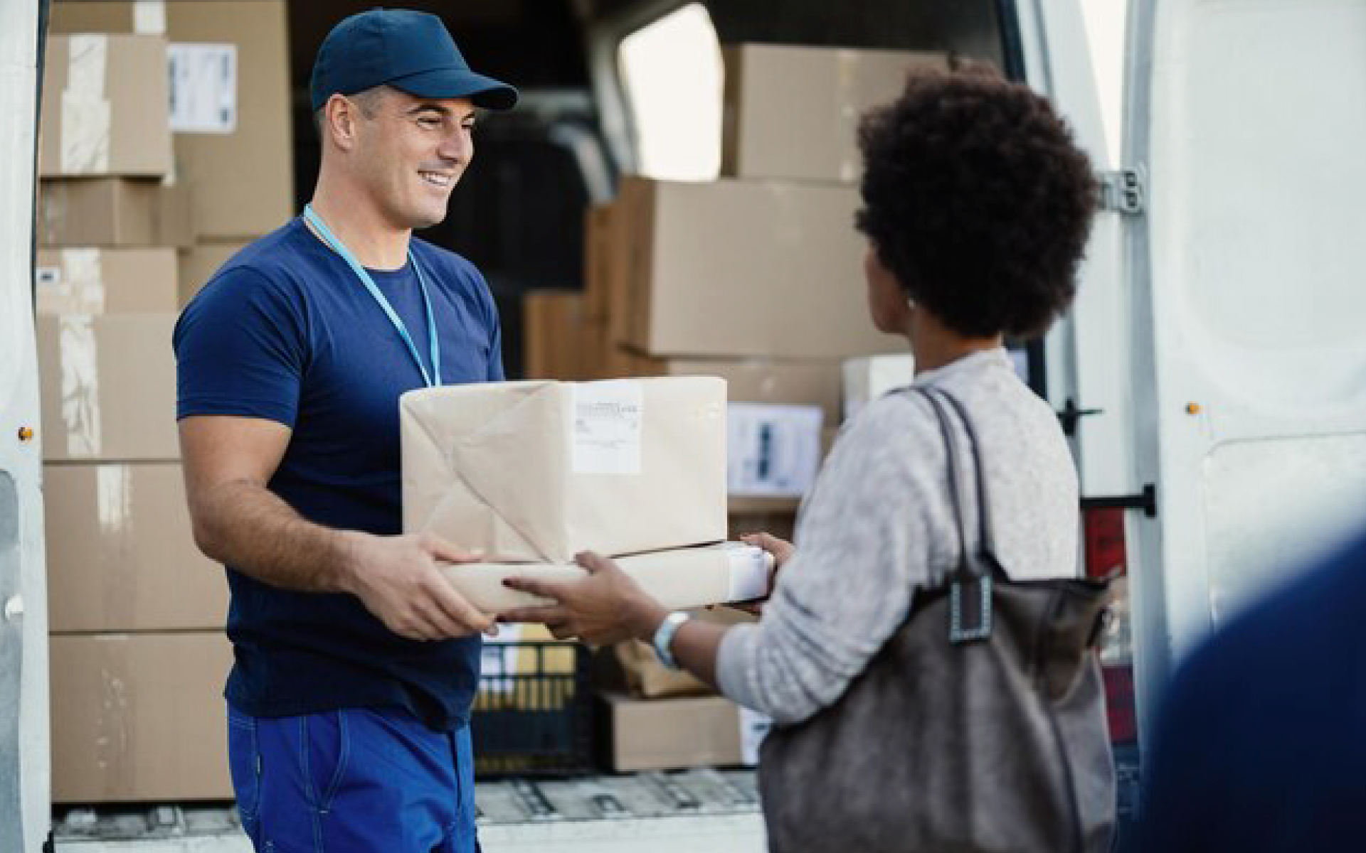 man handing woman a box