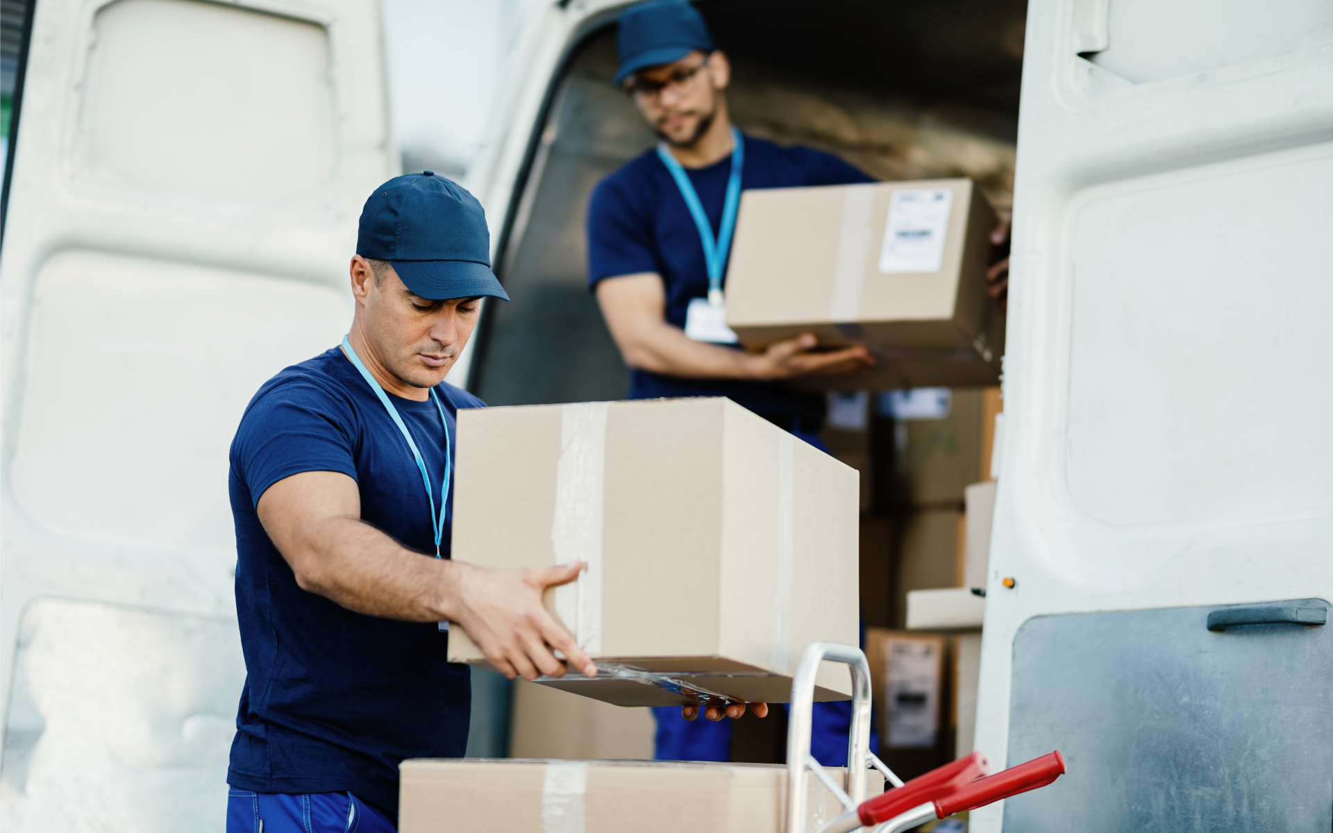 men moving boxes from truck